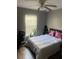 Cozy bedroom featuring a ceiling fan, soft lighting, and ample space for relaxation at 7719 Carriage Pointe Dr, Gibsonton, FL 33534