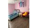 A cozy bedroom featuring wood floors and a single bed with whimsical decorations at 7719 Carriage Pointe Dr, Gibsonton, FL 33534
