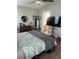 Bedroom features wood floors, decorative mirror, and a view into a bathroom at 7719 Carriage Pointe Dr, Gibsonton, FL 33534
