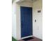 A blue painted front door with a modern lock and welcome sign hanging to the side at 7719 Carriage Pointe Dr, Gibsonton, FL 33534