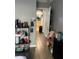 Hallway with tile flooring leading to other parts of the home with shelf storage at 7719 Carriage Pointe Dr, Gibsonton, FL 33534
