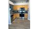 Modern kitchen featuring stainless steel appliances, granite countertops, and tile flooring at 7719 Carriage Pointe Dr, Gibsonton, FL 33534