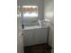 Practical laundry room equipped with a washer, dryer, and storage space at 7719 Carriage Pointe Dr, Gibsonton, FL 33534
