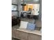 Open living space with wood look floors connecting the living room and kitchen bar seating at 7719 Carriage Pointe Dr, Gibsonton, FL 33534