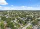This bird's-eye view captures a peaceful neighborhood dotted with homes and mature trees under a bright, sunny sky at 8897 54Th N St, Pinellas Park, FL 33782