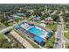 An elevated shot showing a refreshing community pool area nestled within a lush residential neighborhood at 8897 54Th N St, Pinellas Park, FL 33782