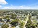 A wide aerial view showcases a dense residential neighborhood with tree-lined streets under a sunny sky at 8897 54Th N St, Pinellas Park, FL 33782