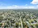 A sprawling aerial view reveals a large residential community with lush greenery stretching to the horizon at 8897 54Th N St, Pinellas Park, FL 33782