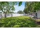 Spacious backyard with green grass, mature trees, enclosed porch and a play set at 8897 54Th N St, Pinellas Park, FL 33782