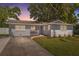 Charming single-story home featuring a welcoming front porch and well-maintained landscaping at 8897 54Th N St, Pinellas Park, FL 33782