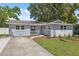 Charming single-story home featuring a welcoming front porch and well-maintained landscaping at 8897 54Th N St, Pinellas Park, FL 33782