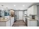 Bright kitchen features stainless steel appliances, granite countertops, and white cabinetry at 8897 54Th N St, Pinellas Park, FL 33782