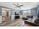 Open living room boasts neutral colors, recessed lighting, and wood-look floors at 8897 54Th N St, Pinellas Park, FL 33782