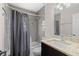 This bathroom features a shower with a bathtub and a modern vanity with attractive countertop at 9105 Camino Villa Blvd, Tampa, FL 33635