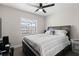 Comfortable bedroom features a large bed, ceiling fan and lots of natural light from a nearby window at 9105 Camino Villa Blvd, Tampa, FL 33635