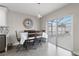 Cozy dining area featuring a modern light fixture, wooden table with seating, and sliding glass doors to the outdoors at 9105 Camino Villa Blvd, Tampa, FL 33635