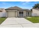 Inviting single-story home with a manicured lawn and attached garage, creating a welcoming curb appeal at 9105 Camino Villa Blvd, Tampa, FL 33635