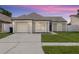Charming single-story home featuring a well-maintained lawn, attached garage, and neutral-toned facade at 9105 Camino Villa Blvd, Tampa, FL 33635
