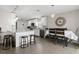 Open-concept kitchen featuring white cabinetry, granite countertops, stainless steel appliances, and an island with seating at 9105 Camino Villa Blvd, Tampa, FL 33635