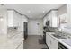Modern kitchen features white cabinets, stainless steel appliances, and stone countertops at 9105 Camino Villa Blvd, Tampa, FL 33635