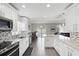 A modern, open-concept kitchen with stainless steel appliances and a view of the dining and living area at 9105 Camino Villa Blvd, Tampa, FL 33635