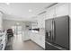 Modern kitchen with stainless appliances, granite countertops, island, and view of dining and living space at 9105 Camino Villa Blvd, Tampa, FL 33635