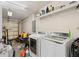 Functional laundry area with washer, dryer, shelving for storage and plenty of extra space at 9105 Camino Villa Blvd, Tampa, FL 33635