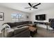 Comfortable living room featuring a large sectional sofa, mounted TV, and stylish decor at 9105 Camino Villa Blvd, Tampa, FL 33635