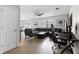 Spacious living room featuring a large sectional sofa, sleek ceiling fan, and hardwood flooring at 9105 Camino Villa Blvd, Tampa, FL 33635