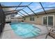 Enjoy the refreshing pool with screened enclosure and the convenience of nearby access to the home at 9105 Camino Villa Blvd, Tampa, FL 33635