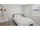 Cozy bedroom featuring a double bed with a marble-patterned comforter at 9107 Rally Spring Loop, Wesley Chapel, FL 33545