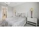 Neutral bedroom featuring two side tables with lamps on either side of the bed at 9107 Rally Spring Loop, Wesley Chapel, FL 33545