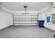 Spacious two-car garage featuring epoxy flooring, utility connections, and an automatic door opener at 9107 Rally Spring Loop, Wesley Chapel, FL 33545