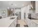 Modern kitchen featuring stainless steel appliances, white cabinetry, and a large island at 9107 Rally Spring Loop, Wesley Chapel, FL 33545