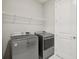 Laundry room featuring a side-by-side washer and dryer with wire rack shelving at 9107 Rally Spring Loop, Wesley Chapel, FL 33545