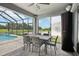 Outdoor patio with dining set and a view of the pool and backyard at 9107 Rally Spring Loop, Wesley Chapel, FL 33545