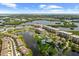 Aerial view of condo buildings, lake, and amenities at 10002 Key Haven Rd # 503, Seminole, FL 33777