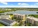 An aerial view shows the proximity of the homes to the lake and the surrounding tropical landscaping at 10002 Key Haven Rd # 503, Seminole, FL 33777