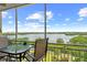 Enjoy breathtaking views of the serene lake from this inviting screened balcony with table and chairs at 10002 Key Haven Rd # 503, Seminole, FL 33777