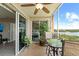 Private balcony with table and chairs offers tranquil lake views and access to a bedroom at 10002 Key Haven Rd # 503, Seminole, FL 33777