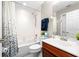 Bathroom featuring a shower over tub, wooden vanity, large mirror, and white tiling throughout at 10002 Key Haven Rd # 503, Seminole, FL 33777