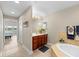 Large bathroom featuring a vanity, bathtub, linen closet and adjacent bedroom at 10002 Key Haven Rd # 503, Seminole, FL 33777