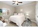 Bright bedroom featuring a ceiling fan, light-colored walls and floors, and a window with natural light at 10002 Key Haven Rd # 503, Seminole, FL 33777