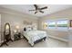 Well-lit bedroom featuring a double bed, ceiling fan, and large window with a water view at 10002 Key Haven Rd # 503, Seminole, FL 33777