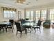 Clubhouse interior featuring round tables, cushioned chairs, and bright, natural light at 10002 Key Haven Rd # 503, Seminole, FL 33777