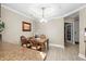Cozy dining area featuring wood table, elegant chandelier, and view into hallway, perfect for intimate meals at 10002 Key Haven Rd # 503, Seminole, FL 33777