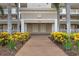 Building entrance with lush landscaping and a brick walkway at 10002 Key Haven Rd # 503, Seminole, FL 33777