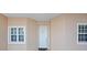 Exterior view of the building entrance featuring a clean, white door with windows and decorative touches at 10002 Key Haven Rd # 503, Seminole, FL 33777