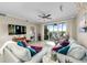 Bright living room with comfortable seating and sliding glass doors to screened in balcony at 10002 Key Haven Rd # 503, Seminole, FL 33777