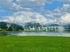 Picturesque pond with fountain, surrounded by green space and buildings at 10002 Key Haven Rd # 503, Seminole, FL 33777
